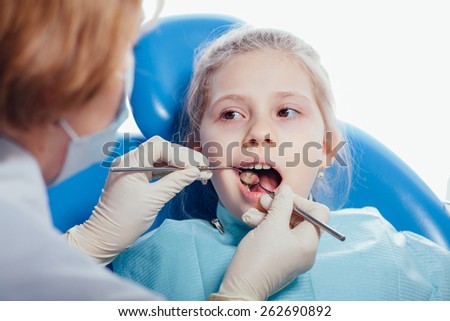 Little girl sitting in the dentists office.