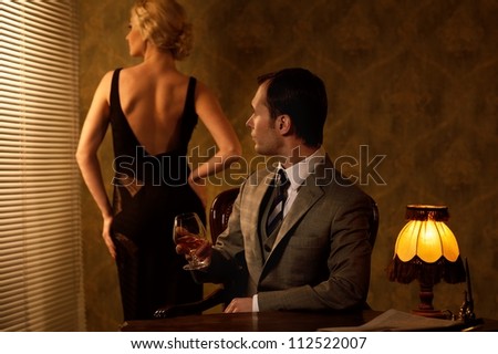 Man in suit with woman behind him