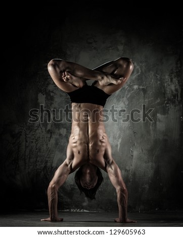 Young b-boy man with naked torso doing brake dancing movements