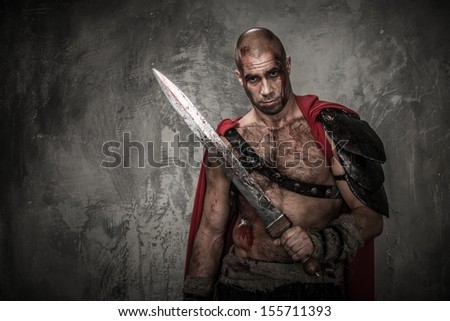 Wounded gladiator with sword covered in blood