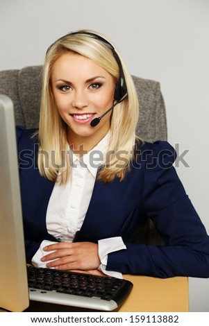 Beautiful blond help desk office support woman with headset