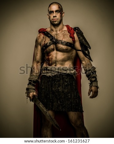 Wounded gladiator with sword covered in blood