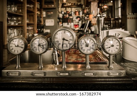 Vintage clocks on a bar counter in a pub