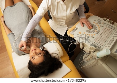 Young woman doing neck ultrasound examination at hospital