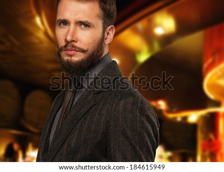 Handsome well-dressed man with beard in jacket and tie