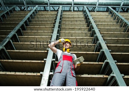 Happy worker in a storage room on a factory