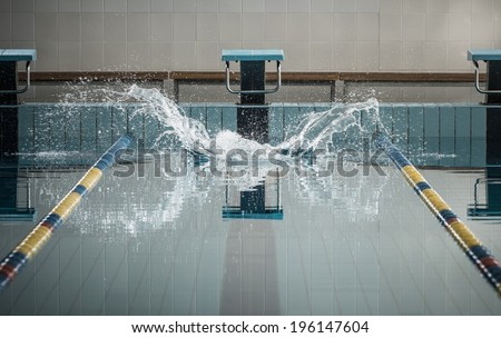 Splashes after swimmers jump in a swimming pool
