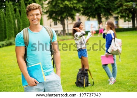 Handsome man student in a city park on summer day