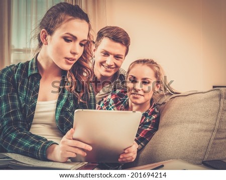 Group of friends with tablet pc in apartment interior