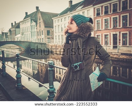 Woman tourist along canal in Bruges, Belgium