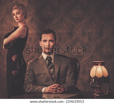 Man in suit with woman behind him