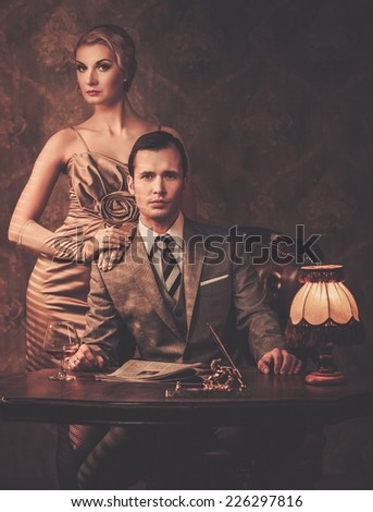 Well-dressed couple sitting behind table