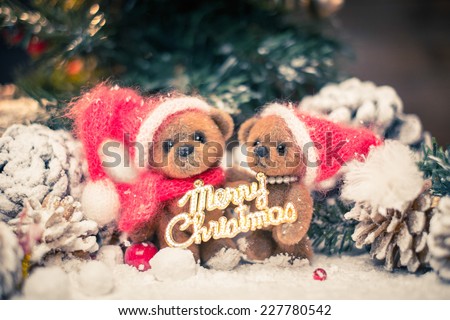 Small toy bears holding Merry Christmas sign in winter holidays still life