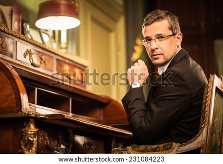 Confident middle-aged man in luxury vintage style interior