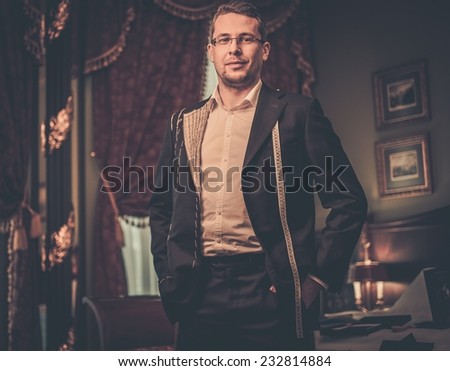 Middle-aged man trying on custom made suit in luxury vintage interior