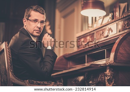 Confident middle-aged man in luxury vintage style interior
