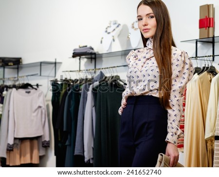 Fashionable young woman in a fashion showroom