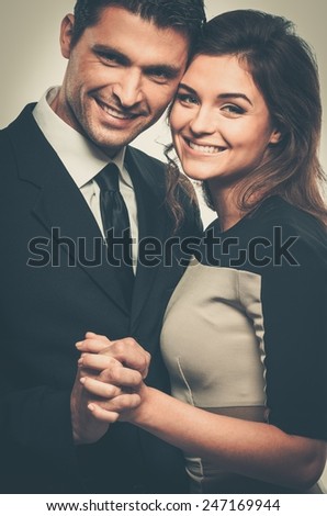 Happy smiling couple in suit and dress