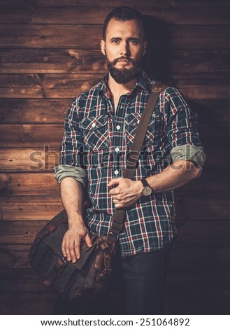 Man with wearing checkered  shirt and messenger bag