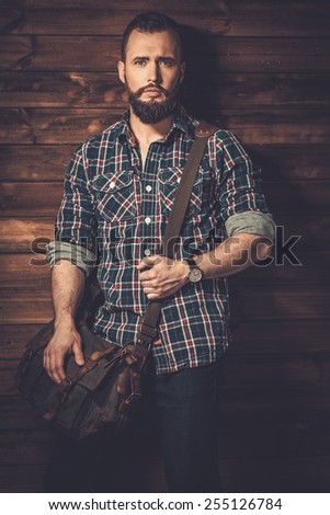 Man with wearing checkered  shirt and messenger bag