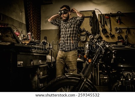 Mechanic preparing ford lathe works in motorcycle customs garage