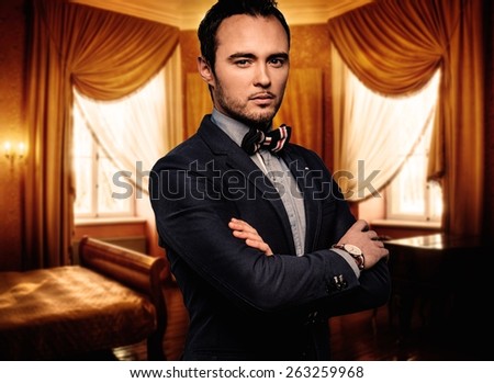 Sharp dressed dandy fashionist in luxury apartment interior