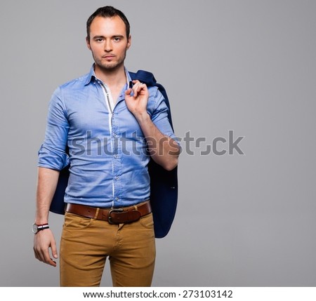 Sharp dressed fashionist with jacket over shoulder