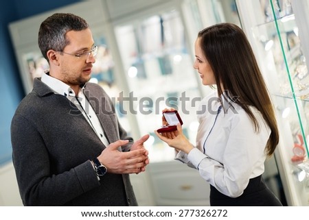 Man with assistant help choosing jewellery