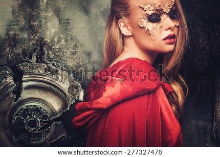Woman with creative carnival mask on her face
