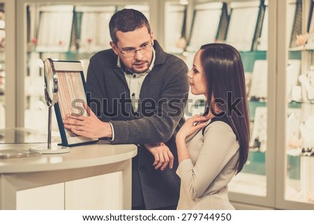 Woman with assistant help choosing jewellery