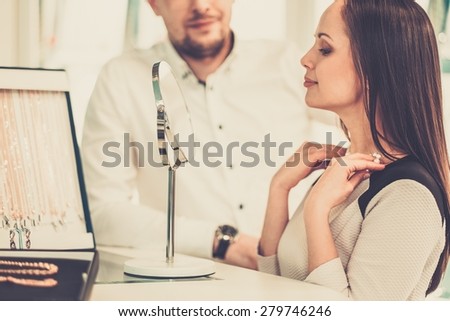 Woman with assistant help choosing jewellery