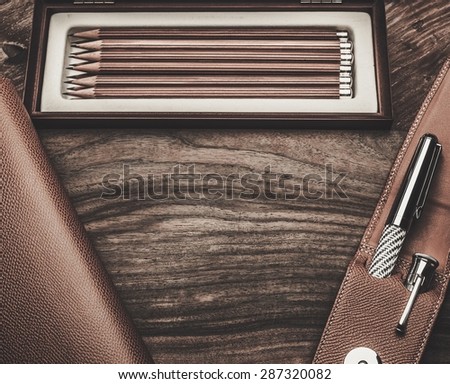 Luxurious writing tools on a wooden table