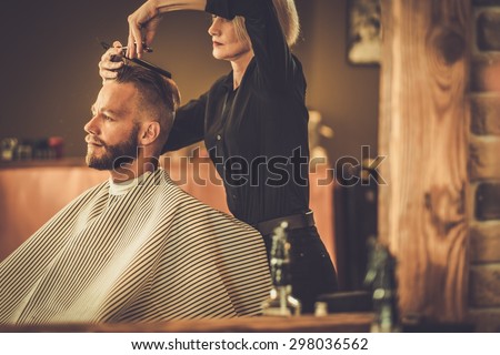 Client visiting hairstylist in barber shop