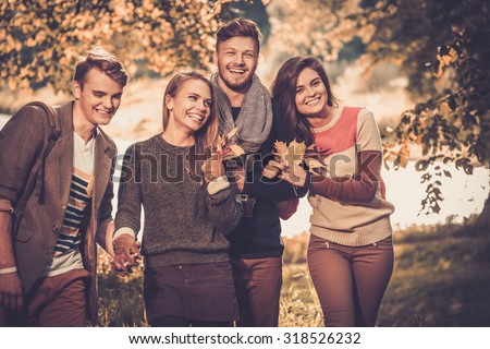 Cheerful friends in autumn park