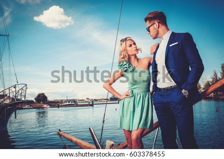 https://image.shutterstock.com/display_pic_with_logo/78238/603378455/stock-photo-stylish-wealthy-couple-on-a-luxury-yacht-603378455.jpg