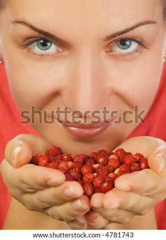 Close-up portrait of a girl with a handful of berries