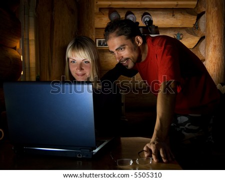 Two friends working on a laptop