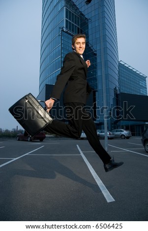 Happy business man running home after work