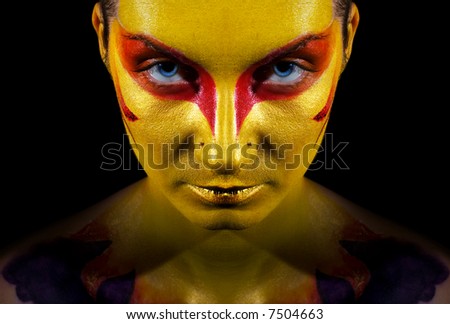 Portrait of a mysterious woman with artistic make-up on her face. Isolated on black background