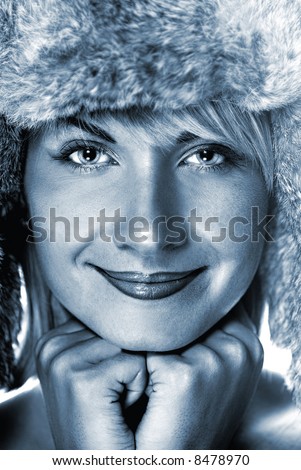 Beautiful girl in winter fur-cap (toned in blue)