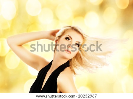 Beautiful blond woman over abstract golden background