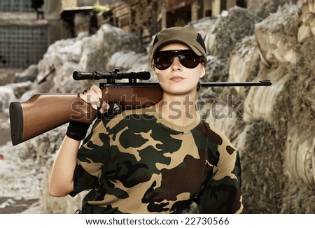 Beautiful woman soldier with a sniper rifle