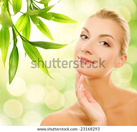 Beautiful young woman applying organic cosmetics to her skin