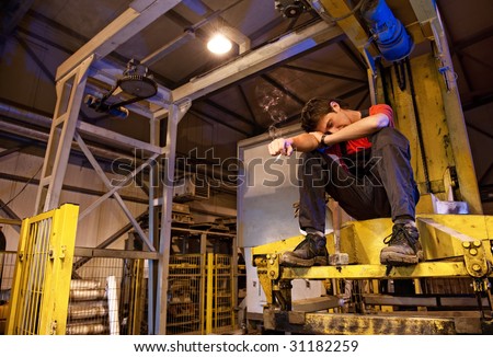 Exhausted factory worker smoking
