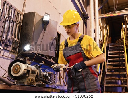 Factory female worker sharpening tools