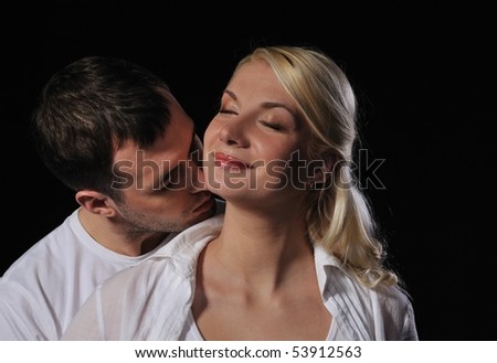 Young couple in love over black background