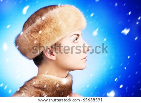 Beautiful young woman in fur cap
