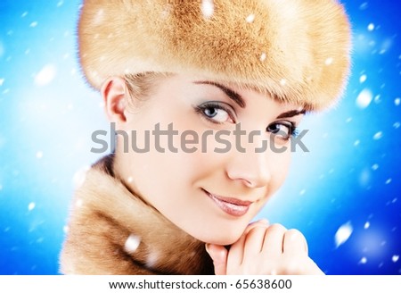 Beautiful young woman in fur cap