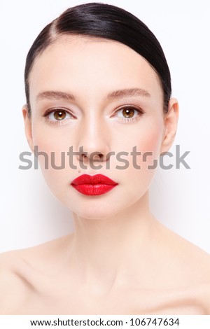 Portrait of young beautiful woman with red lipstick over white wall