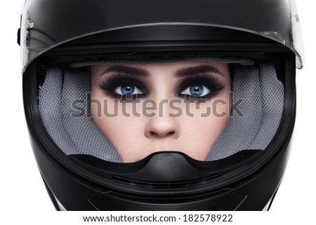 Close-up portrait of young beautiful woman in biker helmet over white background